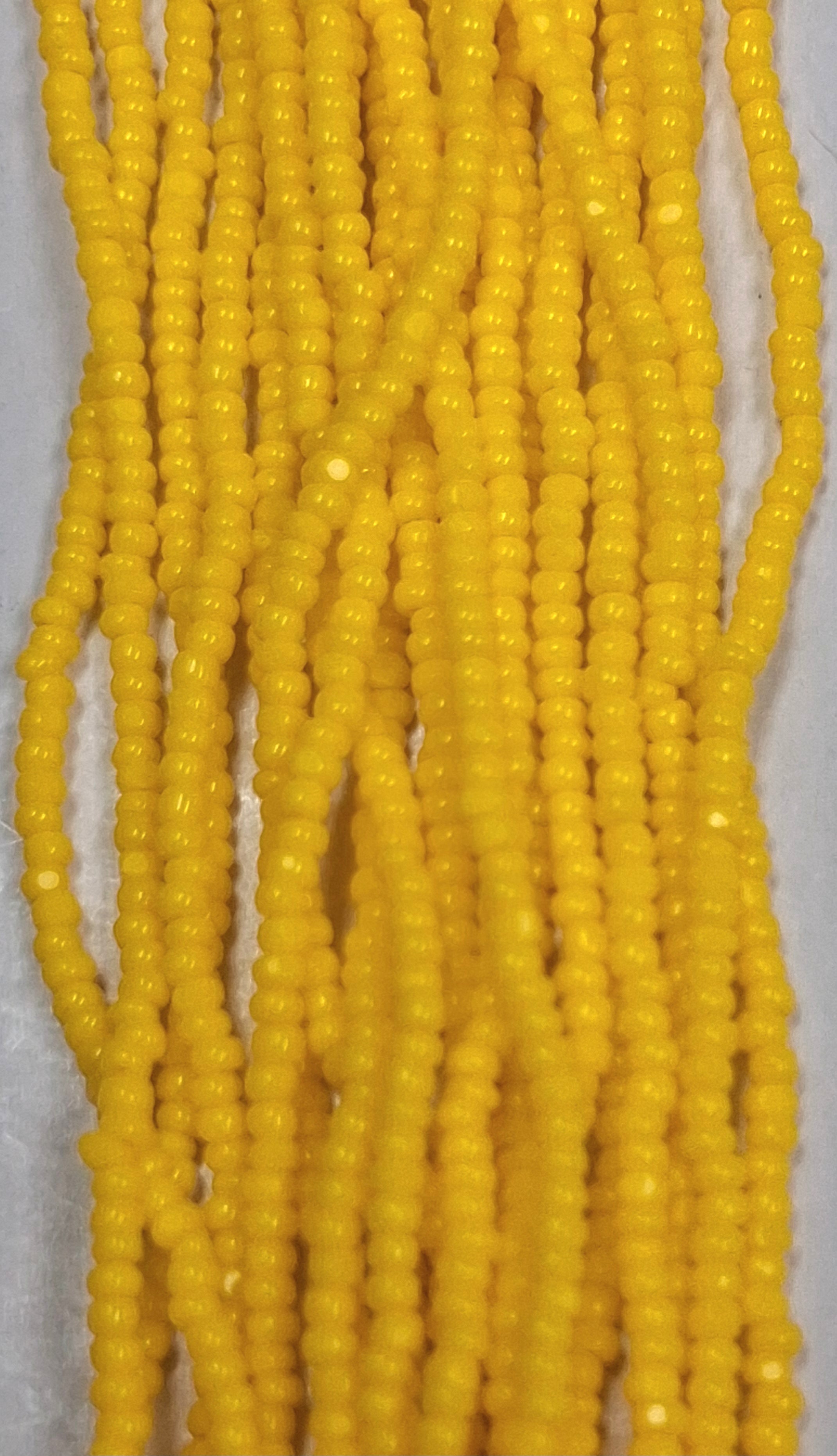 Size 13/0 Charlotte cut seed beads Corn Yellow op full hank