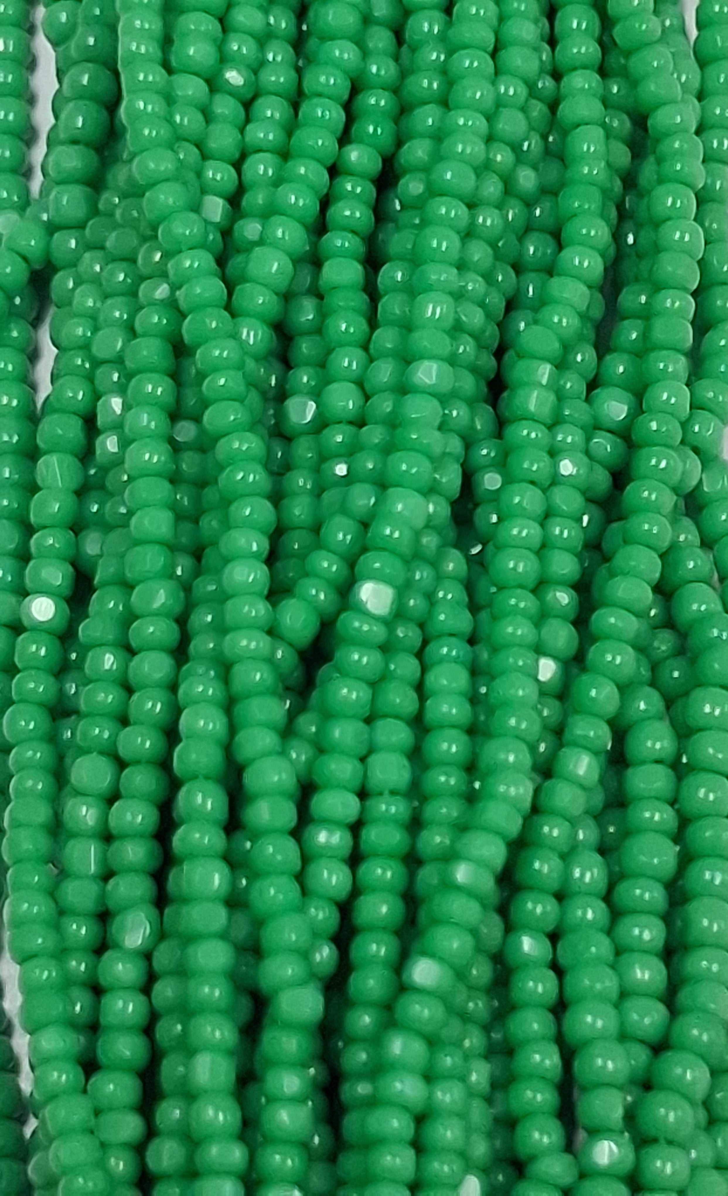 Size 13/0 Charlotte cut seed beads . Green OP full hank