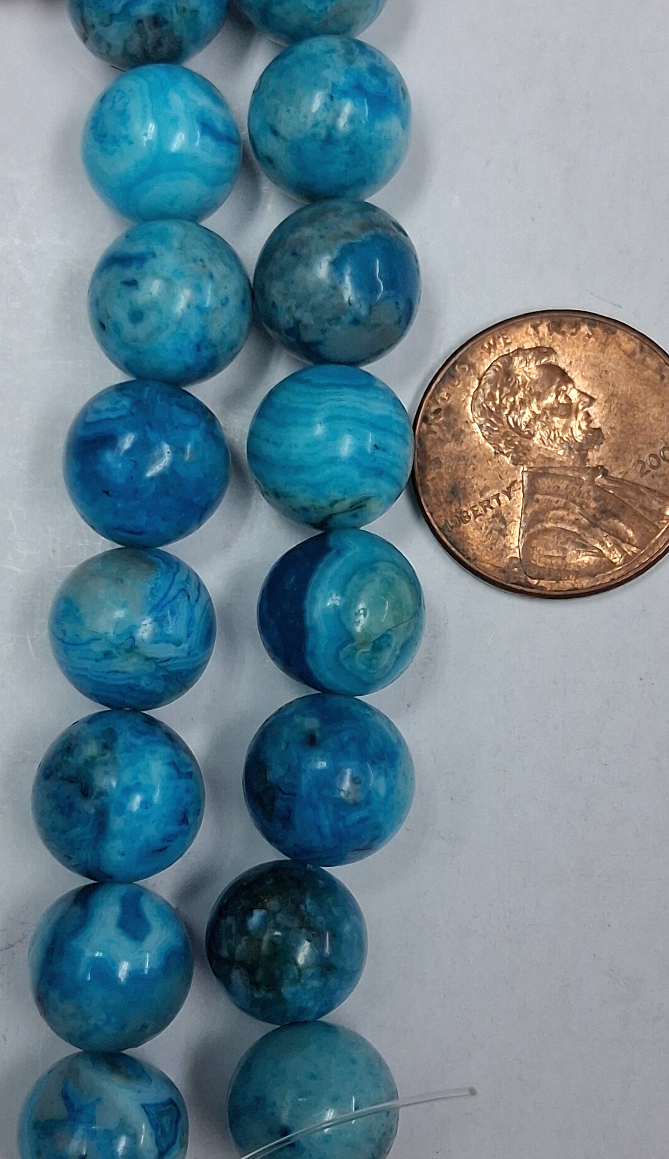 Larimar Crazy Lace Agate  10 mm round beads  8 inch strands