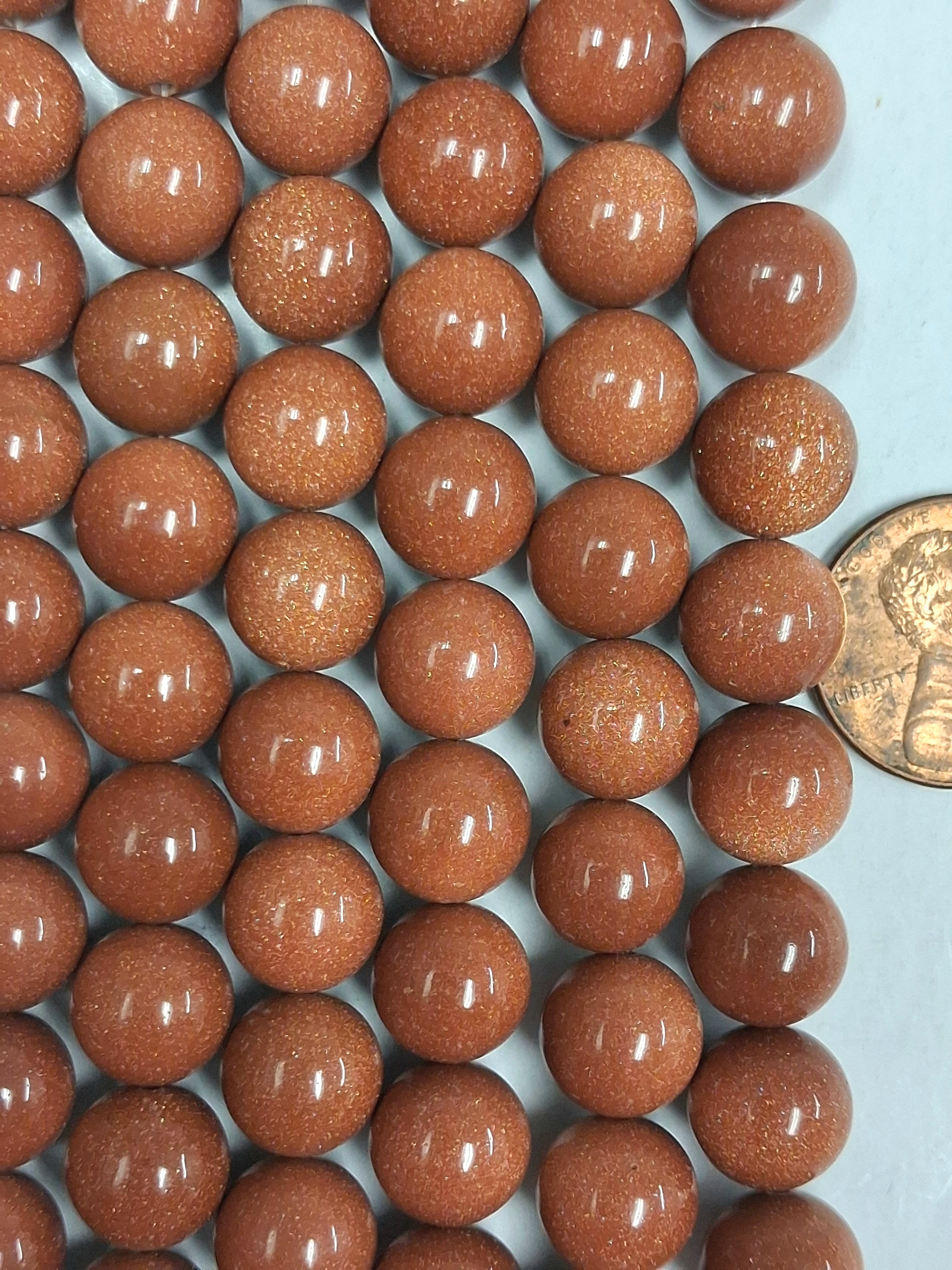 Goldstone  10 mm round beads   7.5 inch strand