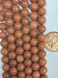 Goldstone  6 mm round beads   7.5 inch strand