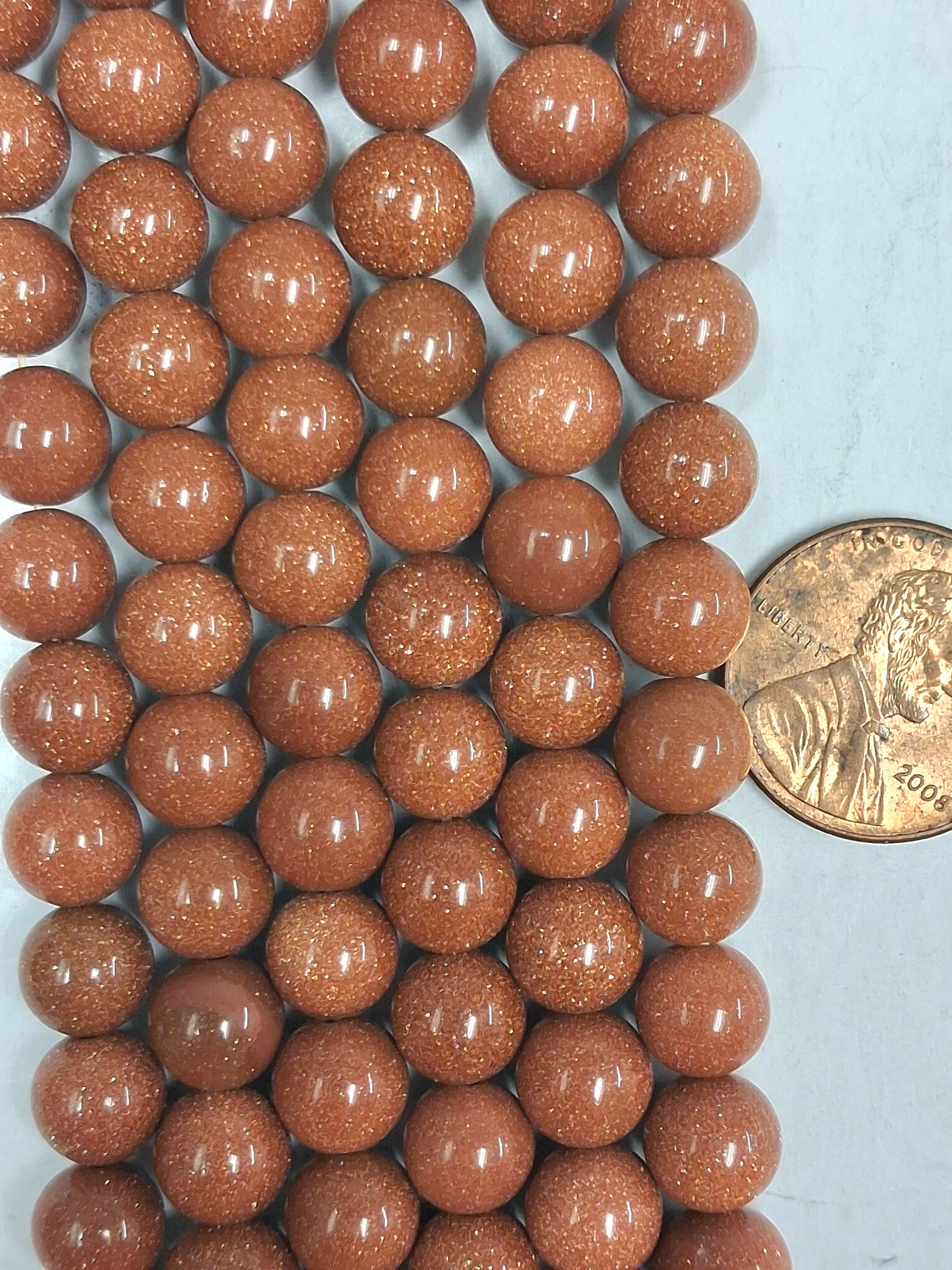 Goldstone  6 mm round beads   7.5 inch strand