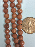Goldstone  8mm round beads   7.5 inch strand