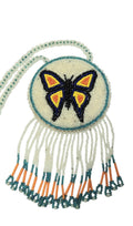3 1/2" Beaded Butterfly Medallion Necklace w/ 29" beaded chain and 2 3/4" fringe. Leather Backing. Clear, blue, orange