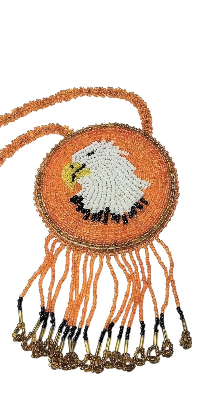 3 1/4" Beaded Eagle Medallion Necklace w/ 28 3/4" beaded chain and 2.5" fringe. Leather backing. Orange, white, beige