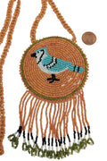 3 1/4" Beaded Blue Jay Medallion Necklace w/ 29" beaded chain and 2 1/2" fringe. Leather backing. Orange