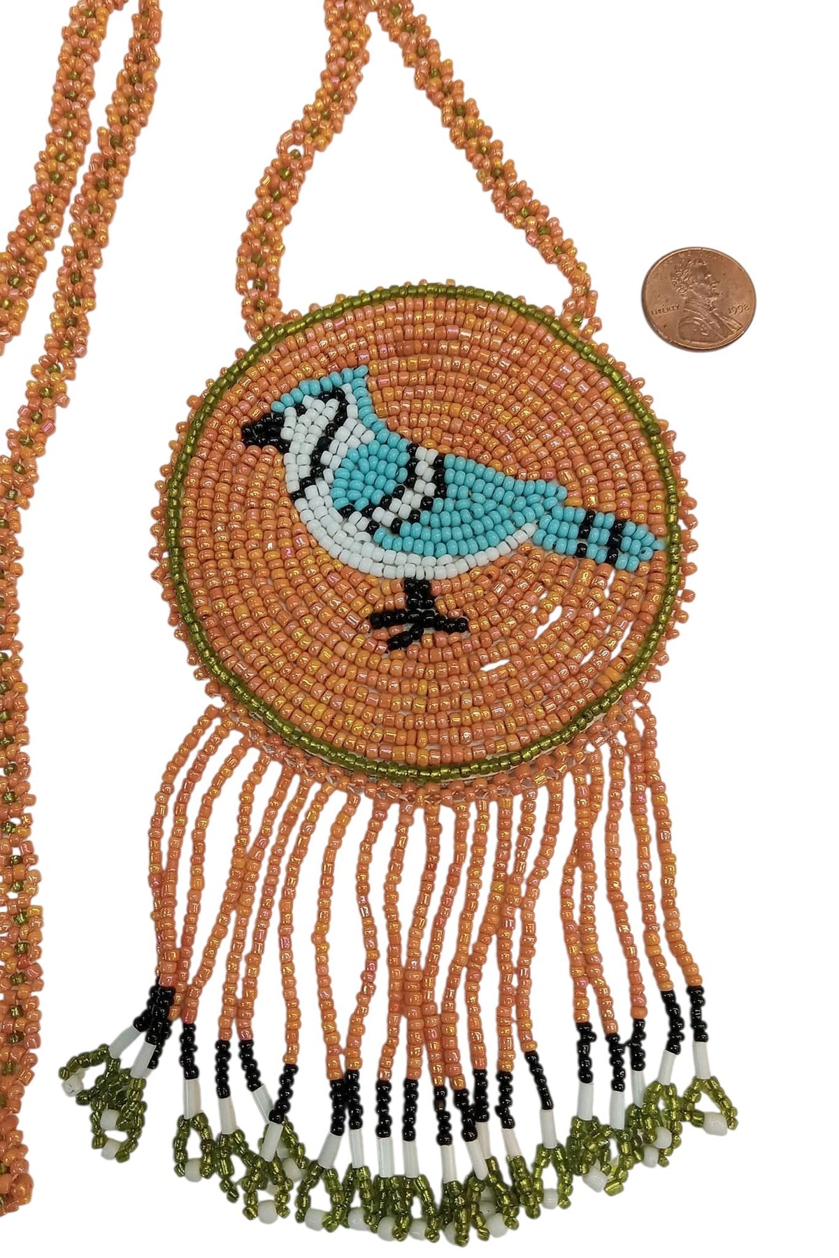 3 1/4" Beaded Blue Jay Medallion Necklace w/ 29" beaded chain and 2 1/2" fringe. Leather backing. Orange