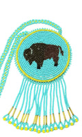 3 1/2" Beaded Buffalo Medallion Necklace w 28" beaded chain and 2.5" fringe. Leather backing. Turquoise