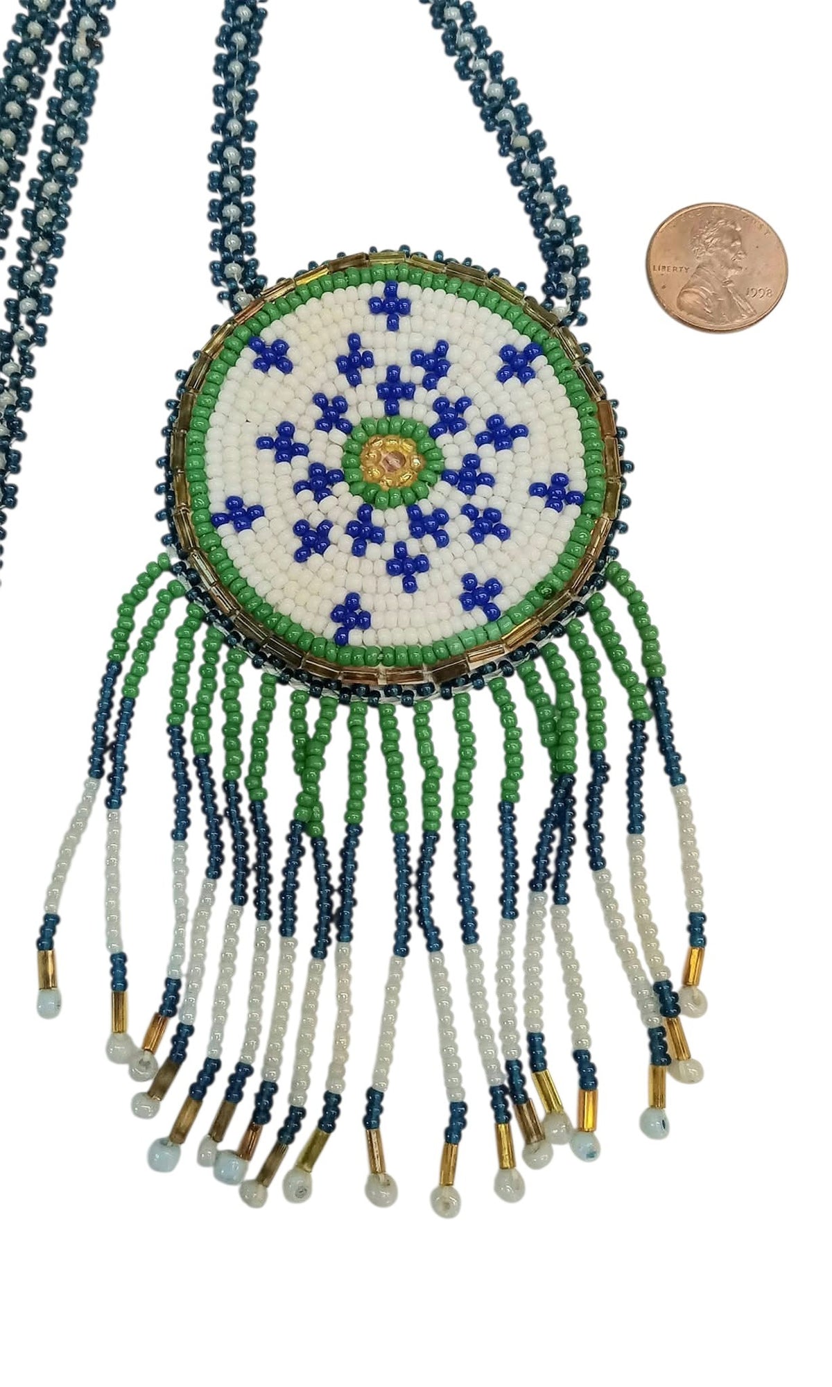 2 1/4" Beaded Geometric Medallion Necklace w/ 29" beaded chain and 2 1/4 " fringe. Leather backing.